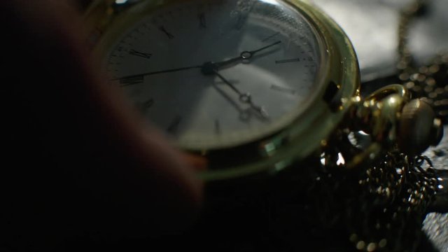 Setting Classic Pocket Watch Ticking in Slow Motion. Small pocket clock in man hands close up. Close-up of hand opening pocket watch. Macro shot 