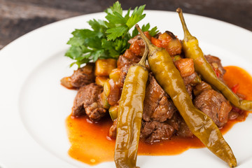 pieces of meat cooked with onion, tomato and pepper