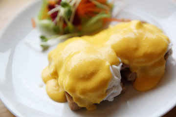 egg benedict on wood background