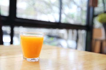 Orange juice on wood background