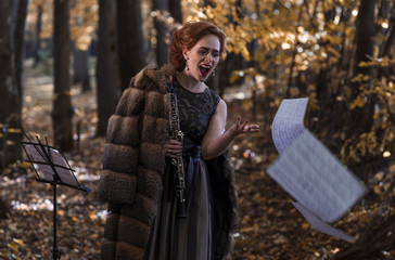 Emotional woman throwing the musical sheets and holding an oboe in hand