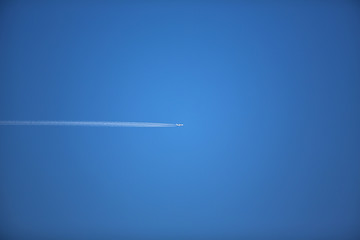 Fototapeta na wymiar plane in the sky over blue background