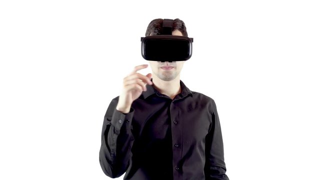 Man wearing virtual reality goggles. Studio video, white background