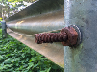 Rusted screw on fence road