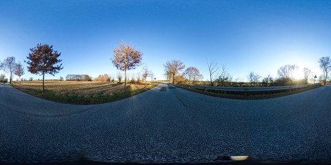 360 degrees spherical panorama of a asphalt country road with trees at late afternoon in autumn -...
