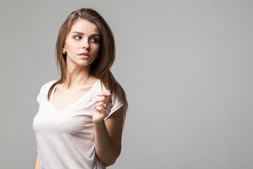 Sensual portrait of beautiful brunette woman posing in studio