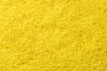 Background of yellow sponge for dishes. Macro