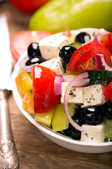 Greek salad with fresh vegetables, feta cheese and black olives. Close up