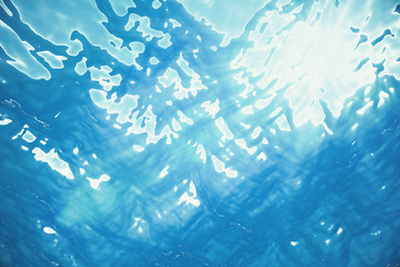 3d rendering blue surface underwater and ripples, with light rays.