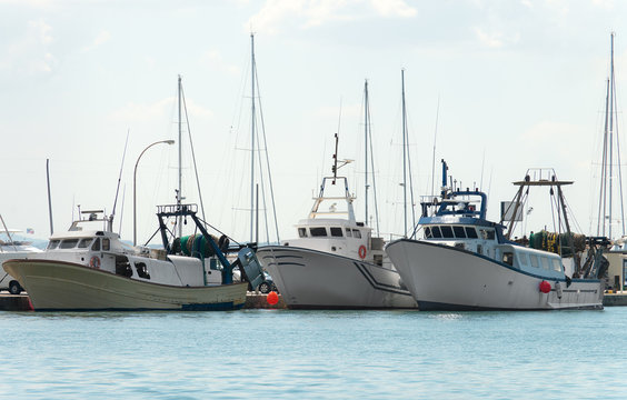 Three fishing vessels in the port.