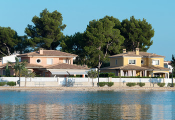 Fototapeta na wymiar Several houses near pond. Alcudia, Mallorca.