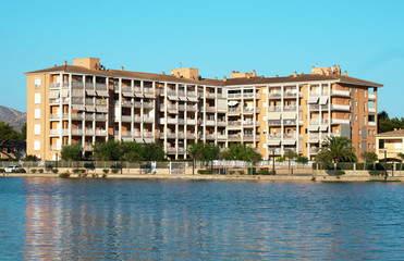 Obraz premium Apartment building near pond. Alcudia, Mallorca.