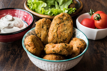 Chickpeas Falafel with sauce , cherry tomatoes and parsley.