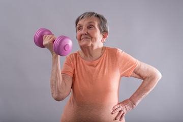 Happy elderly woman doing physical exercices