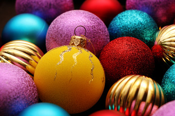 Many multi-colored Christmas balls in box