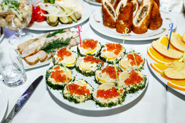 appetizer with red caviar at a festive banquet table