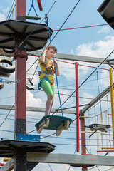 girl in a special gear on a obstacle course passes obstacles