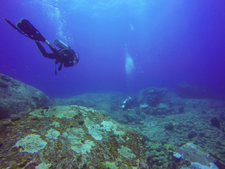 Fototapeta na wymiar Underwater scuba diving selfie shot with selfie stick. Deep blue sea. Wide angle shot.