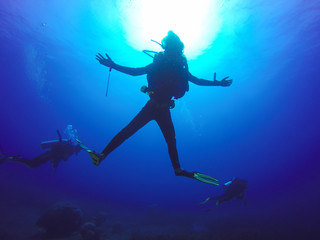 Underwater scuba diving selfie shot with selfie stick. Deep blue sea. Wide angle shot.