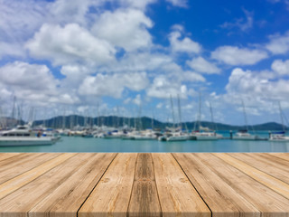 Wooden board empty table in front of blurred background. Perspective brown wood table over blur boat in port background - can be used mock up for display or montage your products. summer season.