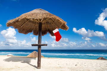 Christmas stocking hanging on thatch parasol