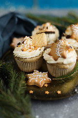 Cupcakes in Christmas style with biscuits and chocolate.