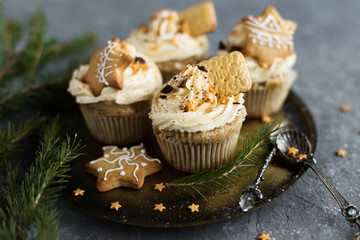 Cupcakes, adorned with Christmas decorations on a gray background