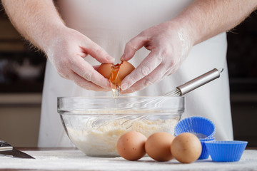 handful of flour with egg on a rustic kitchen. Against the backg