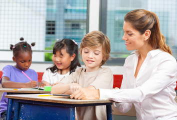 Primary school scene in multi ethnic classroom