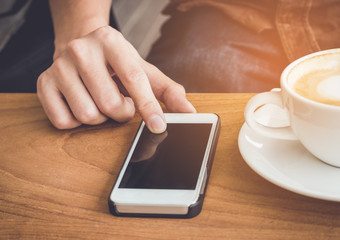 Businessman use mobile phone and coffee cup vintage tone.