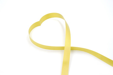 heart made from gold ribbon, on white background