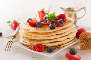 Pancakes with berries and maple syrup