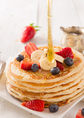 Pancakes with berries and maple syrup