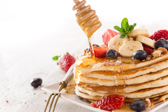 Pancakes with berries and maple syrup