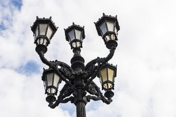 Fototapeta na wymiar Old black lamppost with five lights