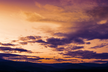 Soft focus winter sunset high up in the silhouette mountains