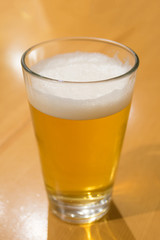 A glass of beer on the wood table