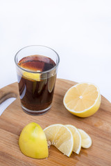 Coke juice with sliced lemons on the wooden board