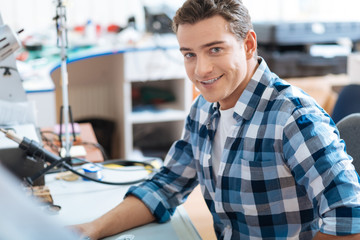 Obraz premium Young man sitting in a workroom