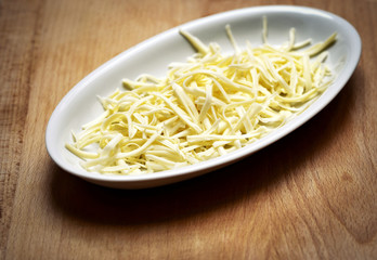 grated hard cheese on a white plate