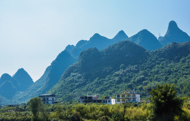 Fototapeta na wymiar The karst mountains scenery with blue sky 