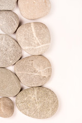 Balanced grey stones over white background with copy space