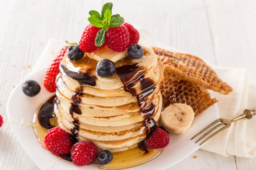 Pancakes with berries and maple syrup