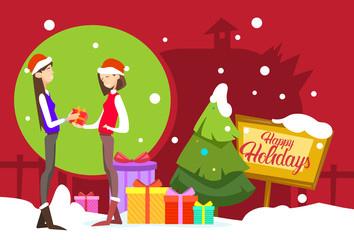 Obraz na płótnie Canvas Two Woman Hold Present Box Gift Merry Christmas And Happy New Year Flat Vector Illustration