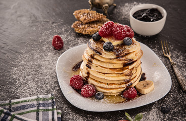 Pancakes with berries and maple syrup