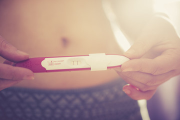 Pregnancy test. Woman and pregnancy tester - obrazy, fototapety, plakaty