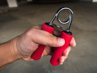 Close-up a man hand exercise by using hand gripper