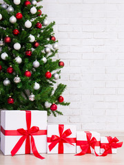 Fototapeta na wymiar christmas background - gift boxes under decorated christmas tree