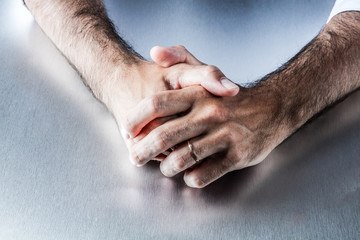 Fototapeta premium anonymous male arms showing symbol of his engagement and wedding ring