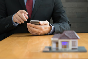 Businessman using mobile application for house property rental